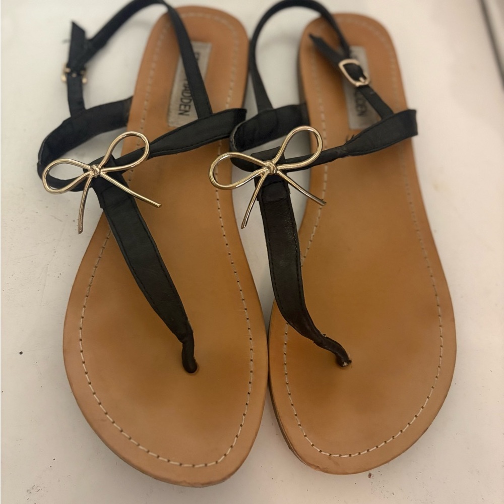 Steve Madden Black Thong Sandals with Gold Bow Accent